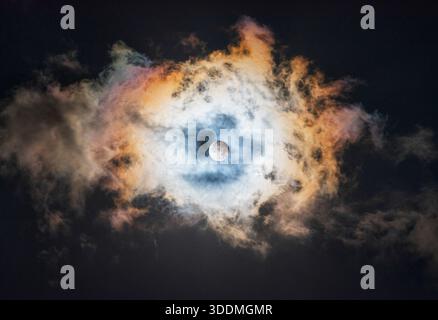 Partial Lunar Eclipse Over a Multicolored Cloudy Sky Stock Photo