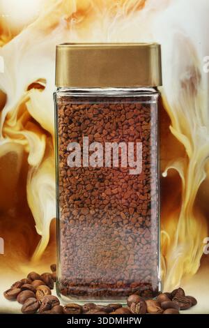 Jar of instant coffee and roasted beans against milk swirls in beverage Stock Photo