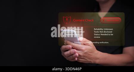 A man holding smartphone with red warning interface showing unverified content, information check, misinformation, fake news, unknow origin, digital r Stock Photo