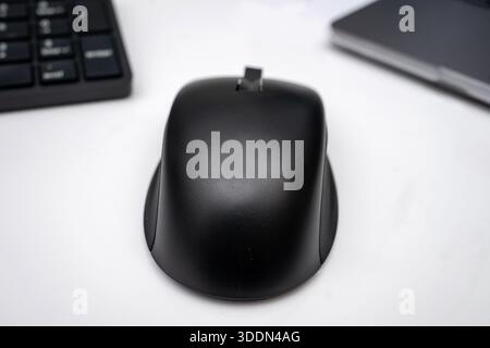 A modern ergonomic computer mouse rests on white background Stock Photo ...