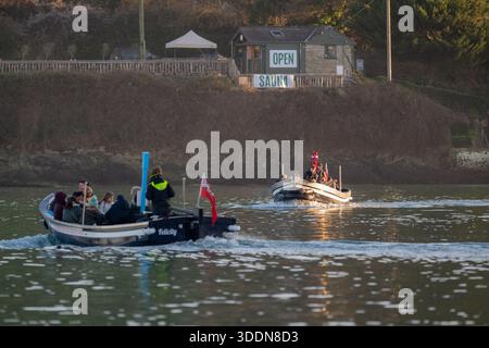 Ferry returning from East Portlemouth towards Salcombe in the golden light of sunset on New Year's eve with 2nd ferry heading in opposite direction Stock Photo