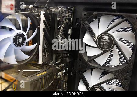 Interior of a gaming PC with branded air cooling system, multiple fans, CPU cooler, graphics card and visible internal hardware Stock Photo