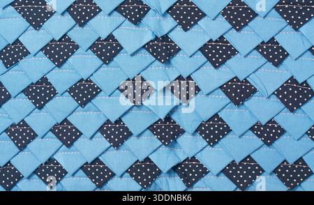 patchwork fabric mat textile surface, overlapping light and dark blue woven material texture, closeup full frame view, textile craft background Stock Photo
