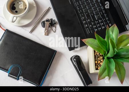 Black Laptop Keyboard Leather Planner Coffee Cup. Overhead Flatlay Of Productive Home Office Setup Featuring Open Laptop Edge, Closed Leather Planner Stock Photo