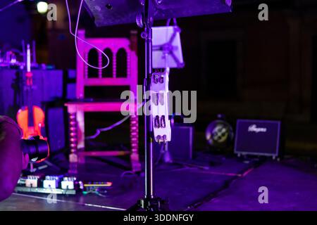 Stage elements and musical instruments create excitement as musicians get ready for a lively night performance outdoors. Stock Photo