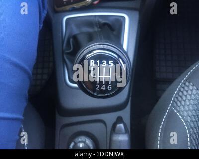 manual gear shifter with white numbers and black plastic in a middle of a car Stock Photo