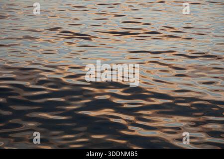 Gradient abstract composition of circular waves and various flowing shapes, enlightened by rose golden hues Stock Photo