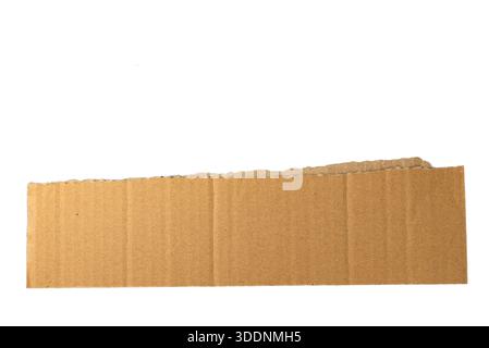 Horizontal corrugated cardboard strip isolated on white, natural kraft texture for packaging, eco, and industrial concepts. Stock Photo