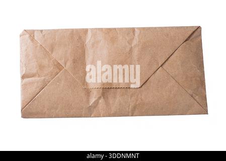 Wrinkled brown paper envelope isolated on white background, vintage mail and correspondence concept. Stock Photo