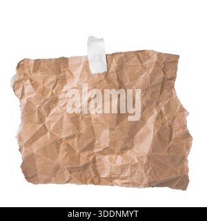 Wrinkled kraft paper piece fixed with tape isolated, rustic memo or notice design element. Stock Photo
