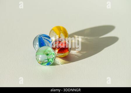 Red, green, yellow and blue cat's eyes marbles Stock Photo