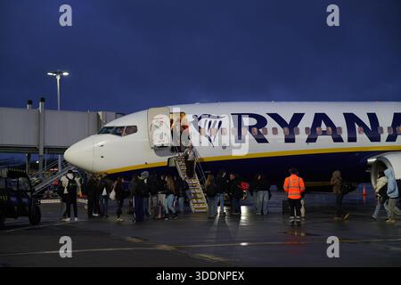 Passengers boarding a Ryanair aircraft via mobile stairs on a wet morning apron.Budapest,Hungary Stock Photo