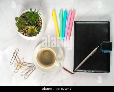 Planner Coffee Colorful Pens Succulent On Marble Workspace With Black Leather Planner, Steaming Mug, Gold Paperclips Scattered, Pastel Markers Aligned Stock Photo