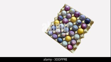 Colorful eggs patterns, 30 eggs, Easter eggs in a paper tray.. Large package of bright Easter eggs, isolated on light grey background. Spring banners Stock Photo