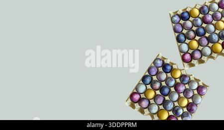 Colorful eggs patterns, 30 eggs, Easter eggs in a paper tray.. Large package of bright Easter eggs, isolated on light grey background. Spring banners Stock Photo