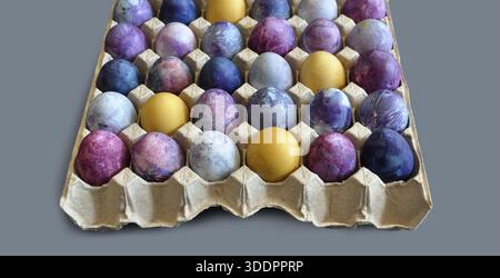 Colorful eggs patterns, 30 eggs, Easter eggs in a paper tray.. Large package of bright Easter eggs, isolated on light grey background. Spring banners Stock Photo