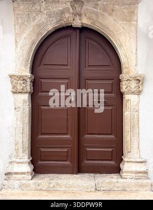 historic building facade with columns and wooden door Stock Photo - Alamy