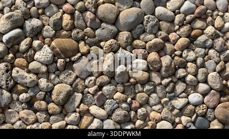 Assorted pebbles and small stones creating a natural texture background Stock Photo