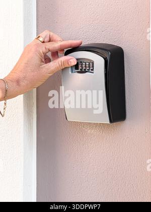 Safe With Key Opening Hand opening safe in hotel room to store valuables Stock Photo - Alamy