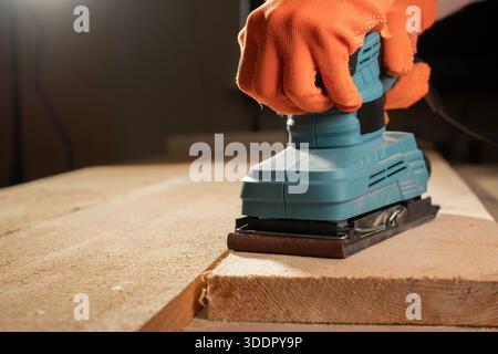male hands using with sander machine on construction concept. Stock Photo