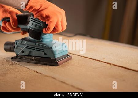 male hands using with sander machine on construction concept. Stock Photo