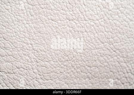Close up of white artificial leather surface. Macro shot of elegant faux skin texture for fashion, furniture, and luxury design. Stock Photo