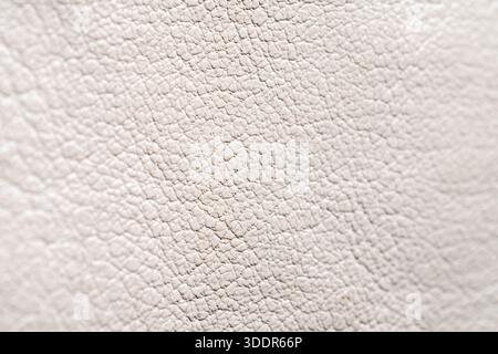 Close up of white artificial leather surface. Macro shot of elegant faux skin texture for fashion, furniture, and luxury design. Stock Photo