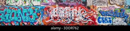 Wide angle panorama of urban subculture street art and murals in the creative district of Metelkova, Ljubljana. Slovenia Stock Photo