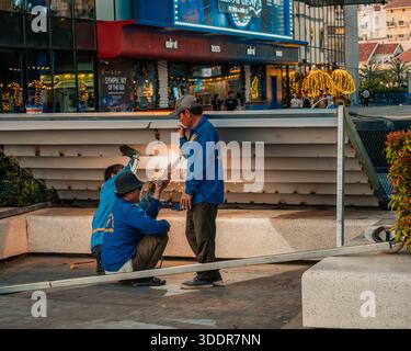 Sunset Town on Phu Quoc Island. December 23, 2025. Construction Workers Welding a Metal Railing in a Sunny Public Plaza with Entertainment Venue in Stock Photo
