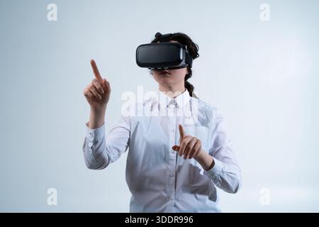 VR designer testing navigation and interface flow using hand gestures inside virtual reality design environment Stock Photo