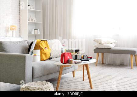 Emergency backpack with necessities on table in living room interior Stock Photo