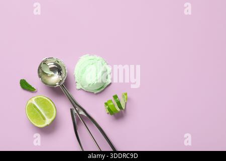 Lime ice cream with mint leaf, metal scoop and peel on purple background Stock Photo