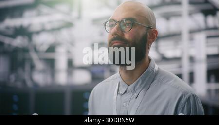 Focused IT Manager Supervising Modern Server Infrastructure. Bearded Male With Glasses and ID Badge Supervising Vast, Infrastructure of Data Center. T Stock Photo