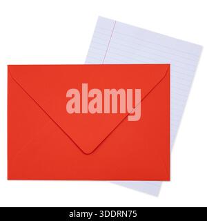 Red envelope lying on a white background with a piece of lined paper. Top view. Stock Photo