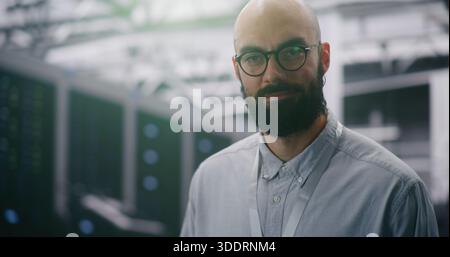 Focused IT Manager Supervising Modern Server Infrastructure. Bearded Male With Glasses and ID Badge Supervising Vast, Infrastructure of Data Center. T Stock Photo