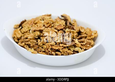 Shelled Organic Walnuts in White Bowl, Natural Plant Based Superfood for Wellness and Mindfulness, Sustainable Green Lifestyle Concept, Botanical Herb Stock Photo
