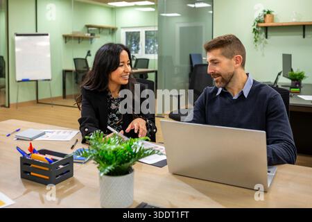 Happy diverse business professionals having fun and collaborating in modern coworking office Stock Photo