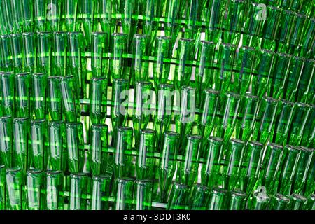 Background of empty green glass bottles.   Recycling and reuse of glass bottles . Stock Photo