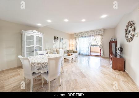 Bright Living and Dining Room Interior with Furniture in mediterranean holiday apartment Stock Photo