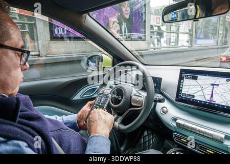 Mexico City Mexico,adult man male Uber driver,senior older man wearing glasses,using smartphone while seated in car,rideshare taxi driver urban transp Stock Photo