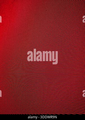 Close-up of red LED display. Abstract digital matrix background with vibrant red pixels - texture of a large video wall. Stock Photo