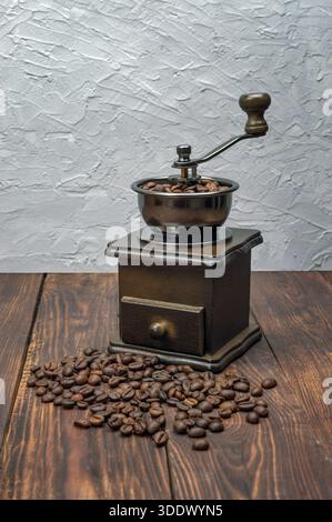 grinder , coffee beans. Roasted coffee beans in a coffee grinder.  wooden background, copyspace. Stock Photo