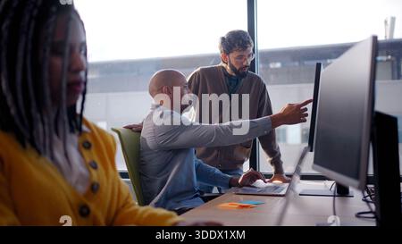 Diverse team meeting in bright corporate office Stock Photo