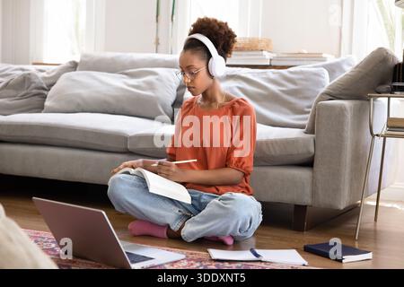 Focused Black student using headphones and laptop for online education Stock Photo