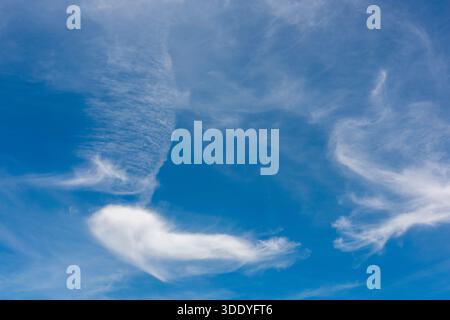 Whispy white clouds on a sunny summers day in New Zealand Stock Photo