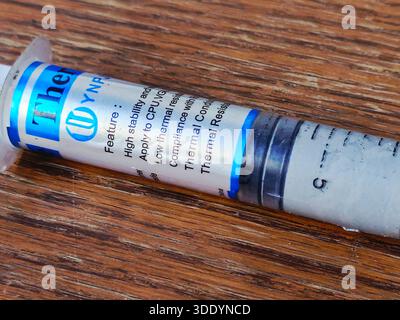 Cairo, Egypt, December 31 2025: YJ-G190 thermal grease, also known thermal paste or compound, a non-conductive, silicone-based, used to improve heat t Stock Photo