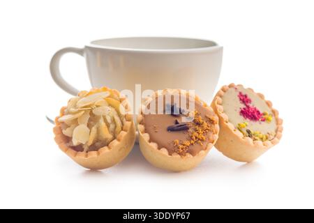 Sweet mini tartlets and coffee cup isolated on a white background. Stock Photo