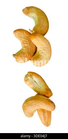 A set of six roasted or baked cashew nuts in two heaps is isolated on white background with clipping path. Stock Photo