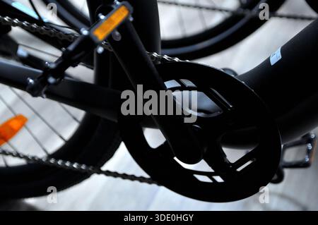 Close-up of bicycle pedal, chain and protective chain guard, technical details, modern urban transportation concept. Stock Photo