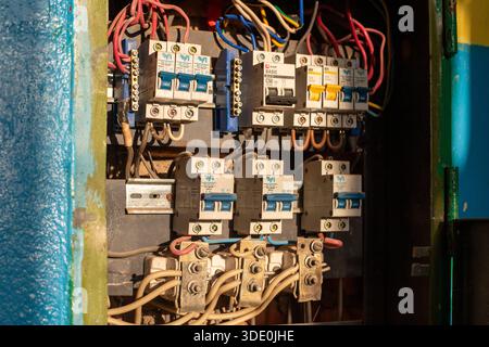 Close-up view of circuit breakers with fuse box or circuit breaker in an old industrial building. Voltage switchboard with circuit breakers. Electrica Stock Photo